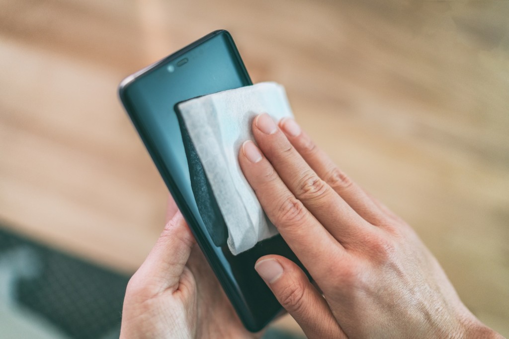 Using disinfectant wipes on smartphone